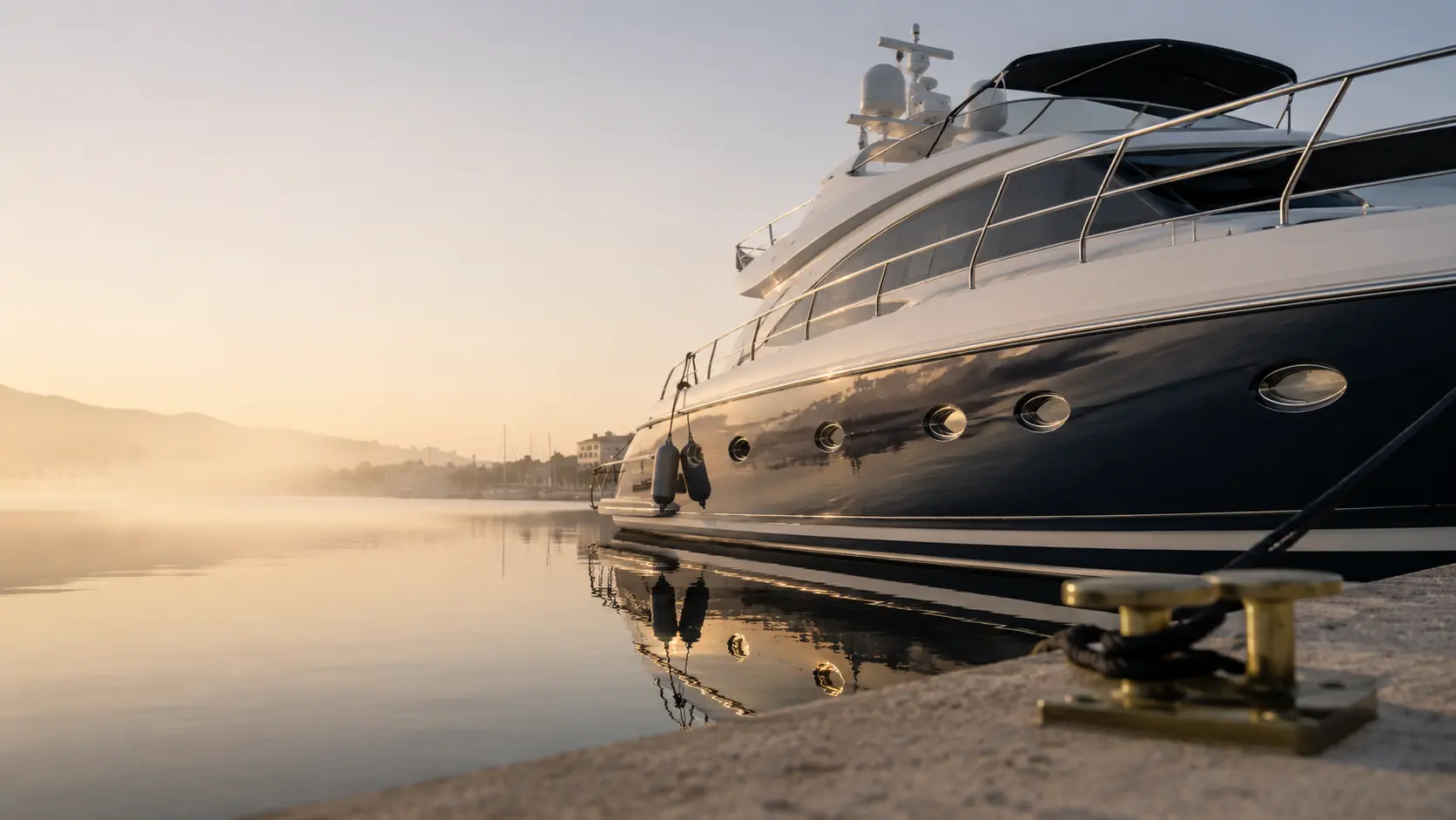 A private yacht at berth in a Mallorcan marina at dawn.